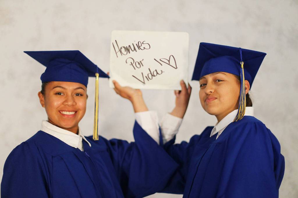 Cadets Marcia Ugalde of Federal Way, left, and Cadet Maria Coronado of Kent hold up a sign that says, &ldquo;Homies for Life&rdquo; before graduation. COURTESY PHOTO