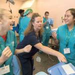 Eve Feller, of Washington High School in Parkland, left, and Tatyana So, of Kent, right, share a laugh as they &ldquo;gown up&rdquo; at MultiCare Nurse Camp on July 19. The five-day camp, now in its 14th year, is designed to get high school students interested in health care careers, particularly nursing. COURTESY PHOTO, Patrick Hagerty