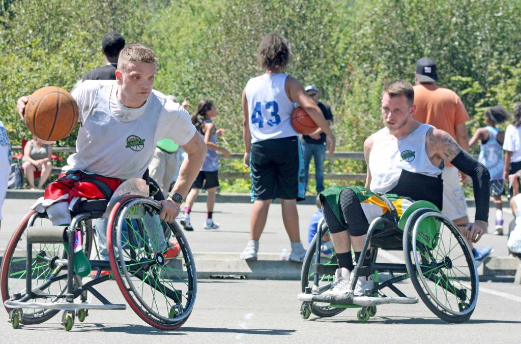 Stuart Olson of Seattle Tonic, looks for an opening against the Odd Squad in wheelchair division play. MARK KLAAS, Kent Reporter