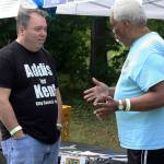 Paul Addis, a Kent City Council candidate, talks to Juan Vega, director of voter registration for KBAC (Kent Black Action Commission) and Hempfest, during the Juneteenth festival on June 17 at Morrill Meadows Park. Vega has participated in the event for each of its six years. KBAC had a voter registration booth at the celebration. MARK KLAAS, Kent Reporter