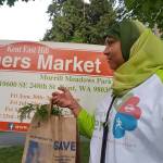 Risho Sapano, Living Well Kent board member, shops at the new farmers market on Kent&rsquo;s East Hill. COURTESY PHOTO