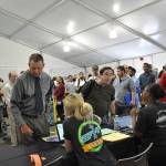Amazon employees help job seekers check in during Jobs Day on Wednesday at the company&rsquo;s Kent fulfillment center. HEIDI SANDERS, Kent Reporter