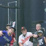 Bob Reynolds, former major-leaguer, observes as kids take turns delivering pitches during the youth baseball clinic at Big League edge. MARK KLAAS, Kent Reporter
