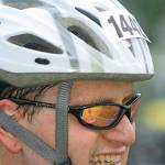 Clockwise, from top, Paul Hunziker, an Olympic-course competitor, breaks into a smile as he buckles up for his bike ride. MARK KLAAS, Kent Reporter