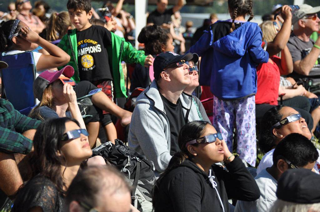 People take in the eclipse at the Museum of Flight. HEIDI SANDERS, Reporter
