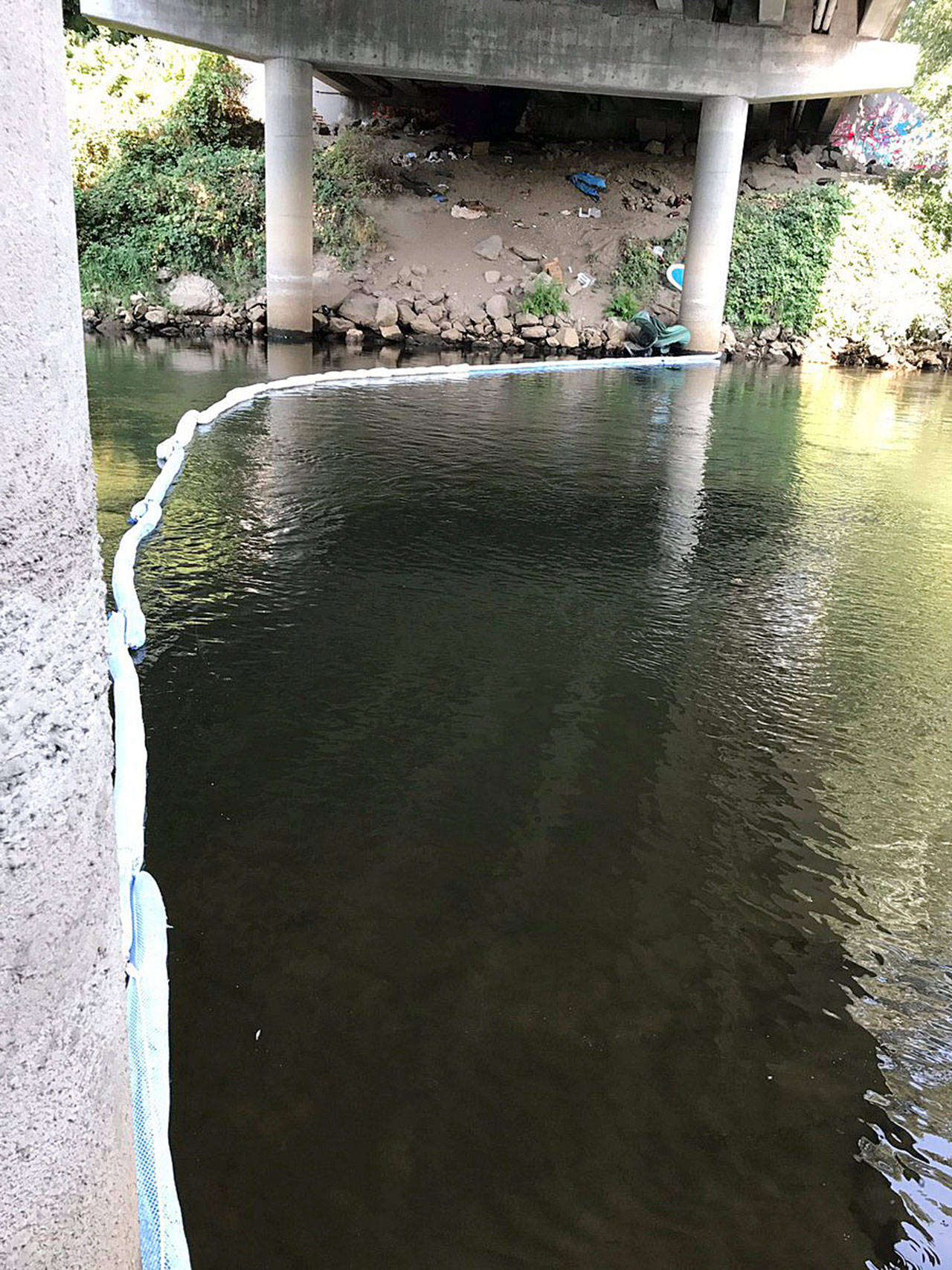 Fire crews set up a boom in the Green River in Kent on Tuesday to help contain a small petroleum spill. Courtesy Photo/Renton RFA
