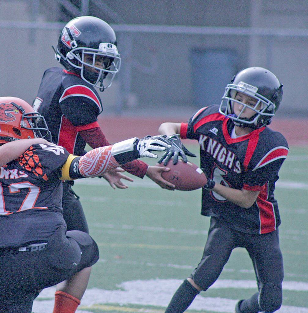 Knights quarterback Mikaio Woods hands off to Trav Ippolito. MARK KLAAS, Kent Reporter