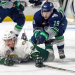 Seattle&rsquo;s Donovan Neuls and Everett&rsquo;s Kevin Davis battle for the loose puck during WHL preseason play Saturday night at the ShoWare Center. COURTESY PHOTO, Brian Liesse, T-Birds
