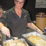 Kari Dixon, of Alki Bakery Cafe and Catering, prepares food for customers to taste. MARK KLAAS, Kent Reporter