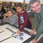 The Kent Chamber of Commerce&rsquo;s Byron Ford, who is part of the chamber&rsquo;s Green River College education committee, works with students in the Kentridge High School library at the STEM field-trip event for middle school girls on Monday. MARK KLAAS, Kent Reporter
