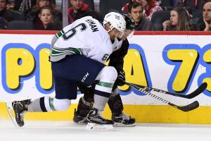 The Thunderbirds&rsquo; Aaron Hyman battles a Calgary player along the boards during WHL play Saturday. COURTESY PHOTO, Candice Ward