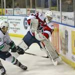 The Thunderbirds&rsquo; Zack Andrusiak applies pressure as Hurricanes goalie Reece Klassen clears the puck during WHL play Sunday in Lethbridge, Alberta, Canada. Andrusiak had a hat trick in Seattle&rsquo;s 7-4 win. COURTESY PHOTO, Cindy Adachi