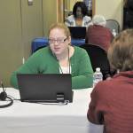 Elizabeth Winders helps a client at the health care enrollment center in Federal Way. The center opened on Wednesday to help South King County residents with their health insurance enrollment questions. HEIDI SANDERS, the Mirror