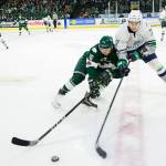 Thunderbirds defenseman Reece Harsch, right, and Silvertips winger Luke Ormsby reach for the puck during WHL play Friday night at Xfinity Arena. COURTESY PHOTO, Chris Mast