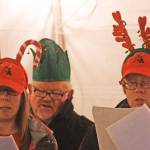 Kent Lutheran Church carolers, from left, Kristin Kettle, Lanny Gleason and Reuben Kettle at 2016 Kent Winterfest. MARK KLAAS, Kent Reporter