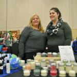 Rita Kay Ajeto, left, and her daughter, Sheil Dodge, owners of Fat Cat Soaps and More, display their handmade candles and soaps during the annual Holiday Bazaar last year at Kent Commons. FILE PHOTO, Kent Reporter