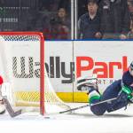 The Thunderbirds Jarret Tyszka reaches to fire the puck past Winterhawks goalie Cole Kehler for the game-winning goal in overtime Saturday night at the access ShoWare Center. COURTESY PHOTO, Brian LIesse, T-Birds