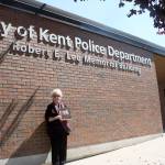 Vicki (Lee) Schmitz stands in August next to the Kent Police building before city officials added Chief in front of her fathers name of Robert E. Lee. FILE PHOTO, Kent Reporter