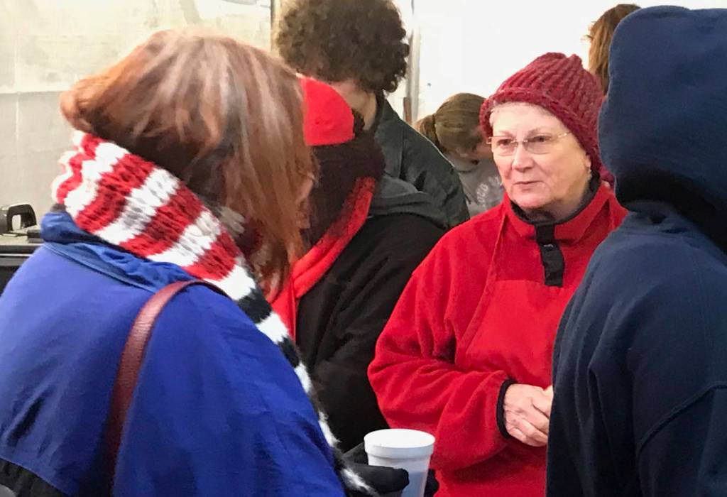 Volunteers serve hundreds of free cups of hot chocolate to festival goers during the celebration. MARK KLAAS, Kent Reporter