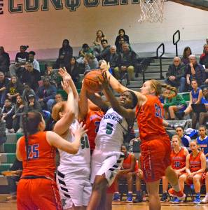 Kentwoods Loriaunna Sanchez battles Auburn Mountainview under the glass during recent action. REPORTER PHOTO, Kayse Angel