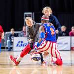 Firefly of the Harlem Globetrotters keeps the ball away from children on Tuesday at the accesso ShoWare Center in Kent. COURTESY PHOTO, @dcongerphoto
