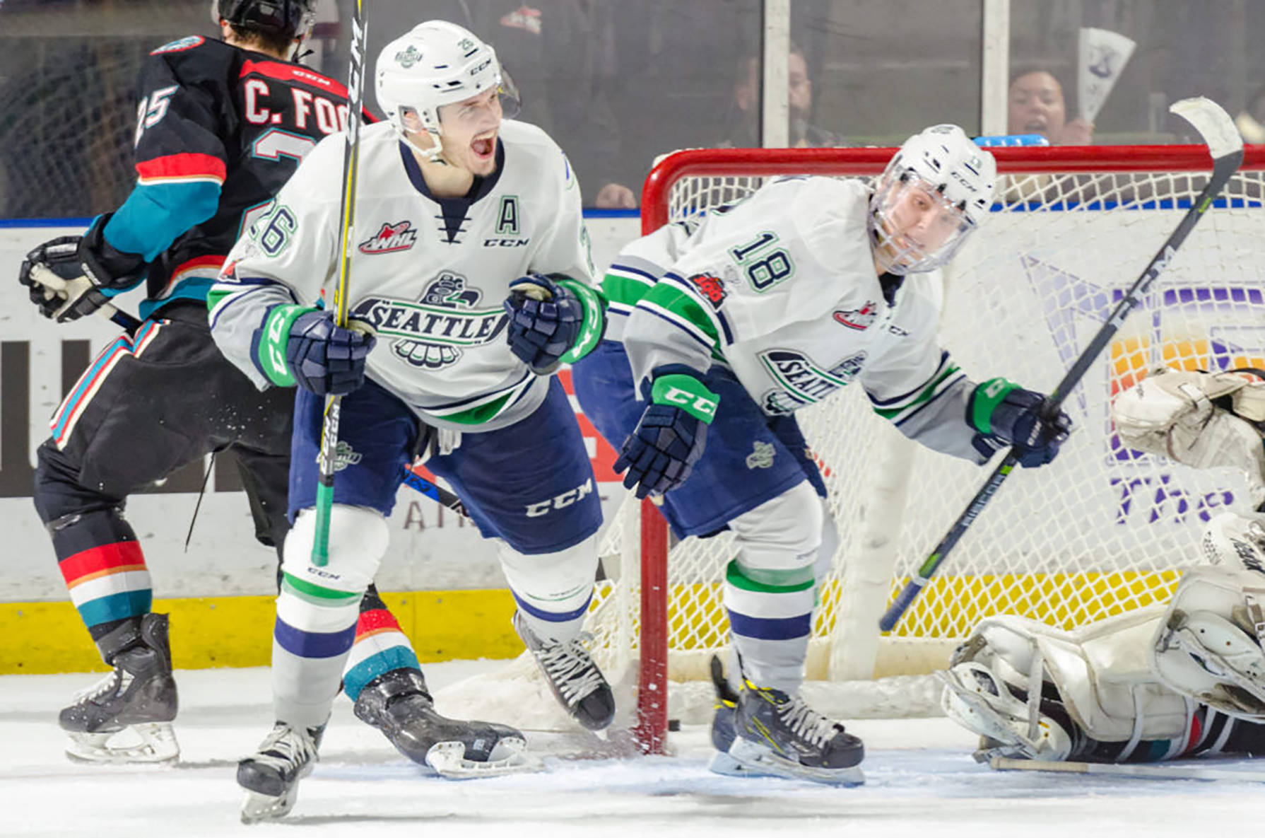 The Thunderbirds Nolan Volcan celebrates one of his three goals with teammate Sami Moilanen, right, in front of the Rockets net during WHL play Friday night. COURTESY PHOTO, Brian Liesse/T-Birds