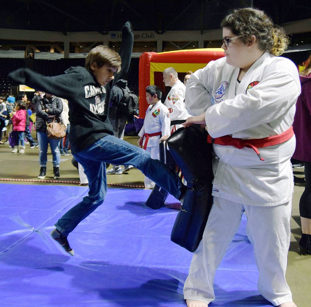 Madison Gonser-Campbell has Brayden Sivana practice his karate moves. RACHEL CIAMPI, Reporter
