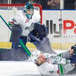Thunderbirds defenseman Turner Ottenbreit slides to deflect the puck in front of goalie Liam Hughes during WHL play Tuesday night. COURTESY PHOTO, Brian Liesse, T-Birds