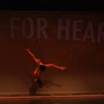 A Kentridge gymnast soars across the stage during Lets Dance for Heart program at the Kentridge Performing Arts Center on Friday. MARK KLAAS, Kent Reporter