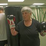 Sylvia Junt and Dave Covey circle the bag in a drill on motion and balance during a Rock Steady Boxing workout at Longevita Pilates Yoga Studio in Auburn last week. The therapy session helps Parkinsons sufferers fight its symptoms.                                MARK KLAAS, Auburn Reporter