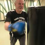 Ted Heikell, 79, of Renton, throws a punch at a bag during a Rock Steady Boxing workout at Longevita Pilates & Yoga Studio in Auburn last week. The therapy session is designed to help those combat symptoms of the disease. MARK KLAAS, Auburn Reporter