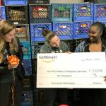 Amazon presents the Kent Food Bank with a surprise $10,000 financial donation to support its logistics operations and programming during its outreach tour of the building March 1. From left are Sally Smith, Amazon Kent fulfillment center general manager; Jeniece Choate, the food banks executive director; and Camico Rivon, the food banks assistant director. MARK KLAAS, Kent Reporter
