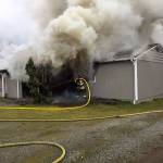 Crews battle a house fire Monday in the 11000 block of Southeast 204th Street. COURTESY PHOTO, Puget Sound Fire