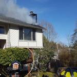 Firefighters put out a house fire that started in the chimney box and extended into the attic on Kents East Hill late Monday morning. COURTESY PHOTO, Puget Sound RFA