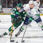 Thunderbirds defenseman Austin Strand, right, battles the Silvertips Bryce Kindopp for the puck during Game 3 playoff action Tuesday night. COURTESY PHOTO, Brian Liesse, T-Birds