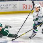 The Thunderbirds Blake Bargar goes after a loose puck in front of fallen Silvertip Patrick Bajkov during Game 4 action Friday night. COURTESY PHOTO, Brian Liesse, T-Birds
