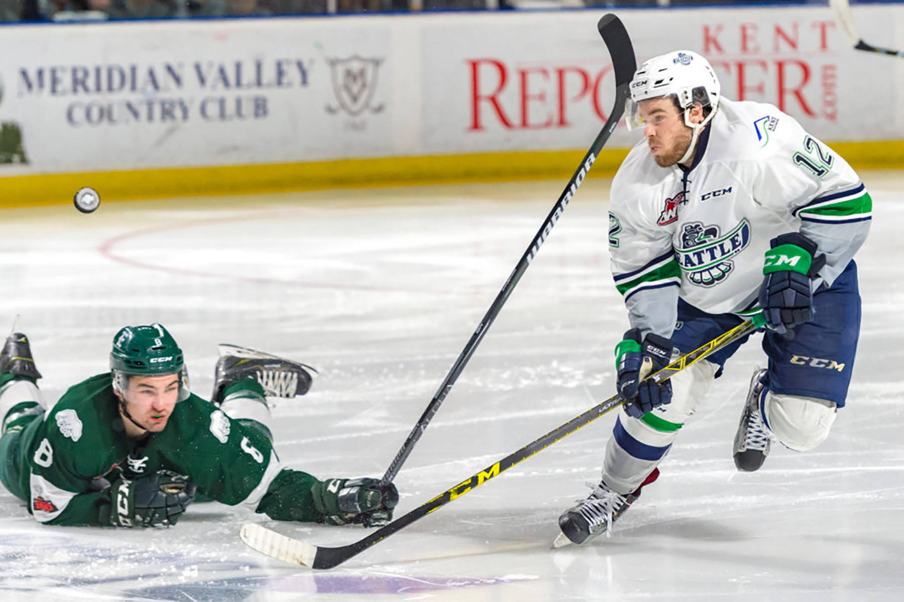 The Thunderbirds Blake Bargar goes after a loose puck in front of fallen Silvertip Patrick Bajkov during Game 4 action Friday night. COURTESY PHOTO, Brian Liesse, T-Birds