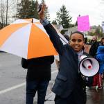 Scenic Hill Elementary fifth grader Ismail Moalim takes charge of the megaphone, leading the crowd with uplifting words on Wednesday outside of Kent School District administrative offices along Southeast 256th Street. He cites his teachers as his inspiration for attending the rally. MEGAN SAUNDERS, For the Kent Reporter
