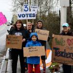 Kent parents and students protest on Wednesday outside of the school district administrative offices in the 12000 block of Southeast 256th Street. The group is against cuts and wants Superintendent Calvin Watts fired or to resign. MEGAN SAUNDERS, For the Kent Reporter