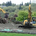 Crews continue to clear the way for development at Riverbends former par 3 golf course this week along West Meeker Street. MARK KLAAS, Kent Reporter