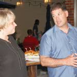 Kent Mayor Dana Ralph, left, and Police Chief Ken Thomas discuss Tuesday night during a gathering at Airways Brewing the rejection by voters of a measure that would have raised utility taxes to pay for more officers. STEVE HUNTER, Kent Reporter