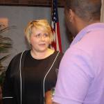 Kent Mayor Dana Ralph talks with a resident after her State of the City address Thursday at City Hall. STEVE HUNTER, Kent Reporter