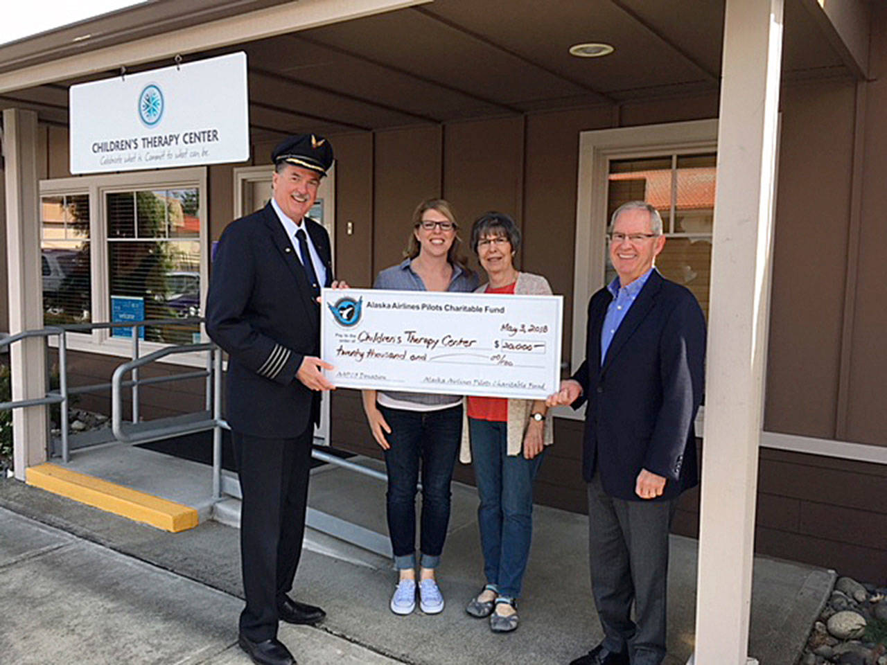 At the ceremony are, from left: Dan Hoffman, president of the Alaska Airlines Pilots Charitable Fund; Laura Anderson, physical therapist at Childrens Therapy Center; Jean Gronewald, friend of CTC; and Barry Gourley, CTC CEO. COURTESY PHOTO