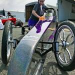 Jordan JoJo Dooley shines her purple Junior Dragster before qualifying at Pacific Raceways last Saturday. Dooley, 14, enjoys the sensation of speed and beating the competition, including the boys. MARK KLAAS, Kent Reporter