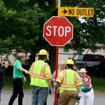 A city of Kent Public Works crew chats with Mayor Dana Ralph and Art Oberto after installing a new street sign Thursday renaming a short section of South 238th Street to Oberto Drive in honor of the jerky companys 100th anniversary this year. The companys headquarters and manufacturing facility sit at the end of the street. STEVE HUNTER, Kent Reporter