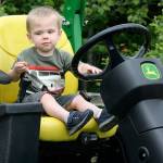 Derek Volland, 1, of Bonney Lake, checks out a mower at the annual City of Kent Public Works Department demonstration day at the accesso ShoWare Center on Thursday. Derek attended the event with his brother Dylan, 3, his mother Desiree and his father Todd Volland, a city mechanic. STEVE HUNTER, Kent Reporter