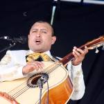 Salvador Morales, of the Mariachi Conquistadors de Mexico, strums a number during the groups performance on the Plaza Stage at the Kent International Festival at the ShoWare Center on Saturday. MARK KLAAS, Kent Reporter