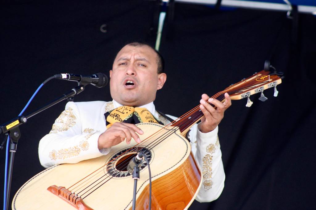 Salvador Morales, of the Mariachi Conquistadors de Mexico, strums a number during the groups performance on the Plaza Stage at the Kent International Festival at the ShoWare Center on Saturday. MARK KLAAS, Kent Reporter