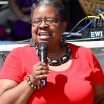 Kent City Councilmember Brenda Fincher welcomes the sun-splashed crowd while introducing the next performer on stage at the Kent International Festival last Saturday. MARK KLAAS, Kent Reporter
