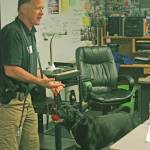 Detective John Lewitt, of the Seattle Police Departments arson/bomb squad, introduces Boomer to students in Jesse Merrys sixth grade class during career day at Meridian Elementary School. MARK KLAAS, Kent Reporter